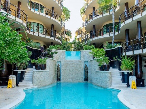 Beachfront department for sale in Playa del Carmen – pool with view of condos in the background