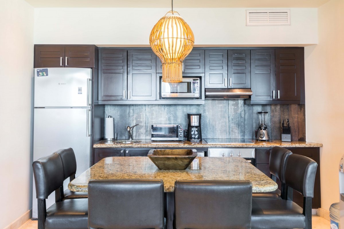 Beachfront apartment for sale in Playa del Carmen—dining area with full kitchen at the back