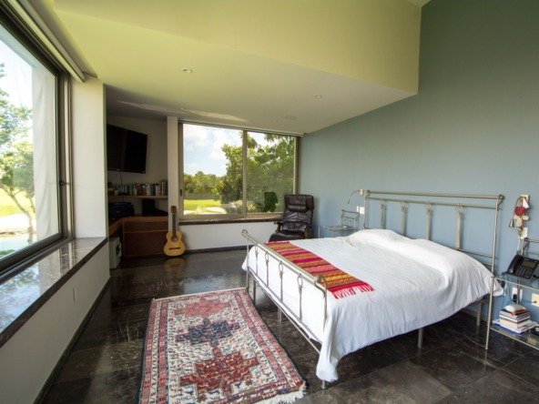 House for sale in Cancun Country Club – master bedroom with view toward the bed and side window