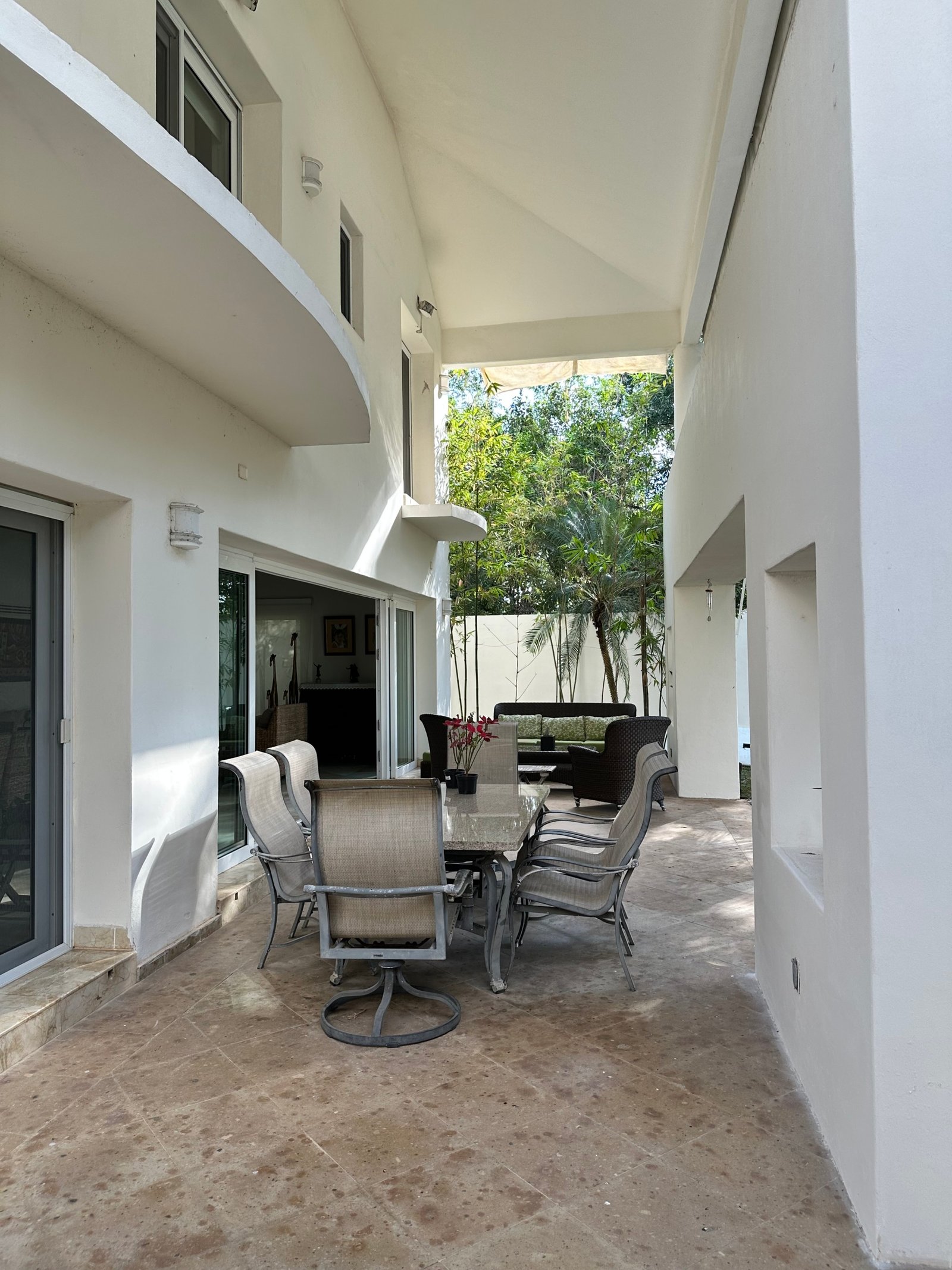 House for sale in Lagos del Sol, Cancun – cozy outdoor space with palm trees in the back.