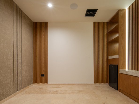 House for sale in Puerto Cancun – modern interior with vertical wood panels and textured wall cladding