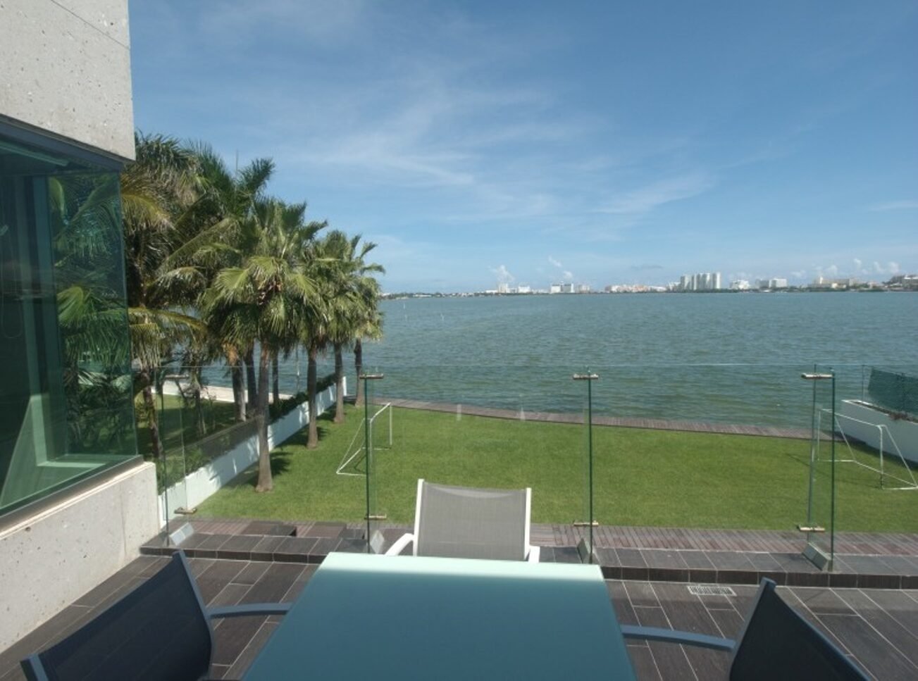 House for sale Isla Dorada Cancun – balcony view toward lagoon with hotels in the background