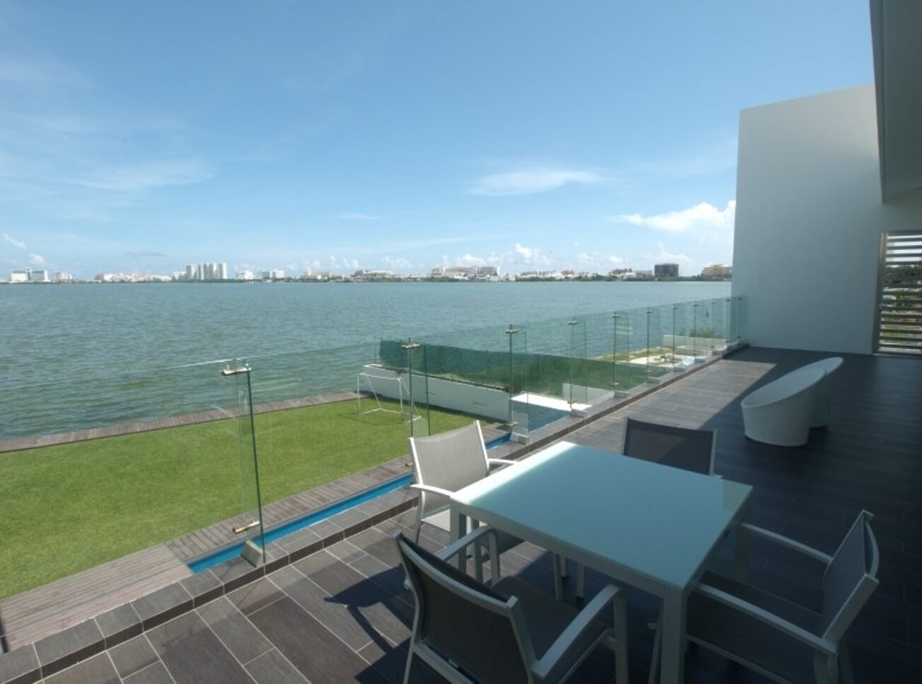 House for sale Isla Dorada Cancun – balcony overlooking the lagoon with hotels in the background