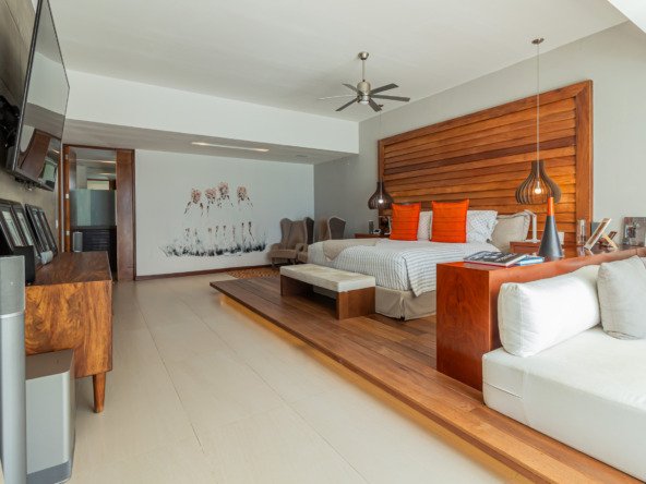 House for sale in Isla Dorada, Cancun hotel zone – spacious modern bedroom with orange accents