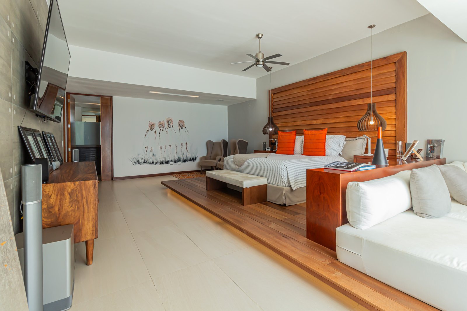 House for sale in Isla Dorada, Cancun hotel zone – spacious modern bedroom with orange accents