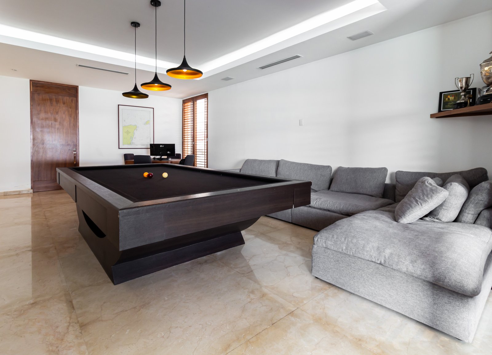 House for sale Isla Dorada hotel zone Cancún—game room with a modern dark-wood billiard table and pendant lights