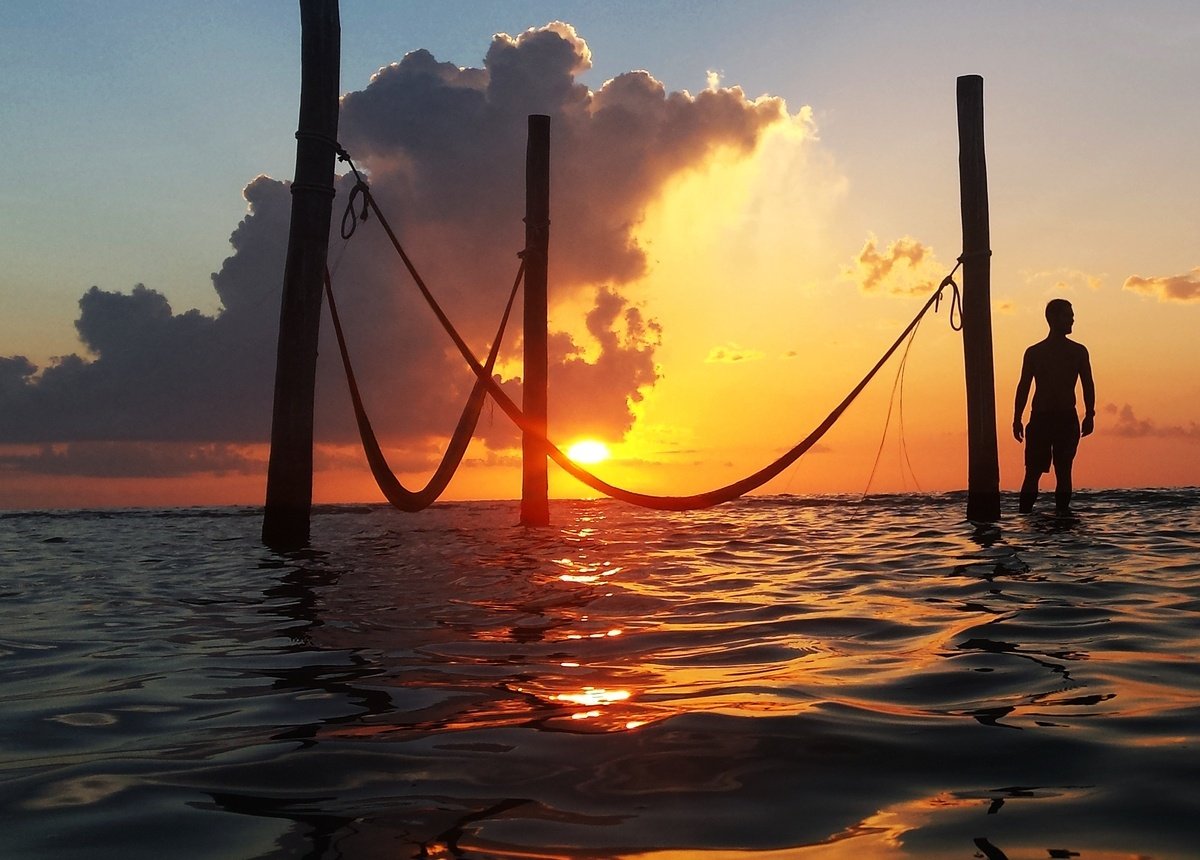 Land for sale on Holbox Island – sunset over the sea, with hammocks over the water